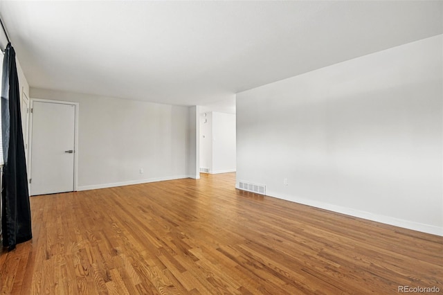 6948 W 70th Ave, Arvada, CO 80003 - spare room with light wood-style floors, baseboards, and visible vents