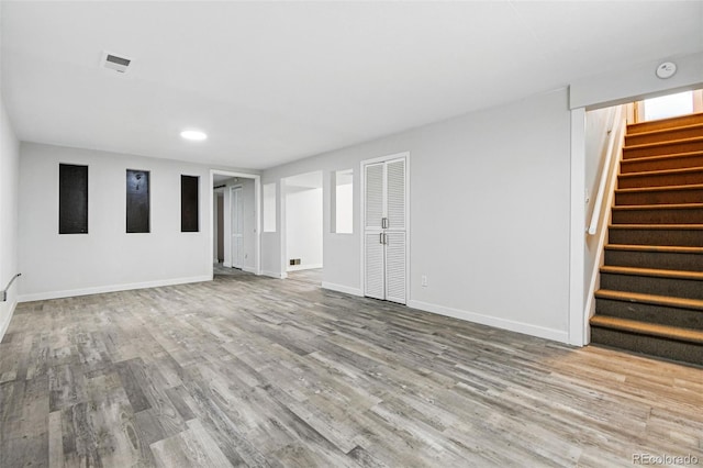 6948 W 70th Ave, Arvada, CO 80003 - finished basement featuring baseboards, stairs, wood finished floors, and visible vents