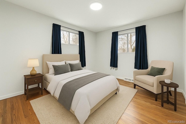 6948 W 70th Ave, Arvada, CO 80003 - bedroom featuring light wood-style flooring and baseboards