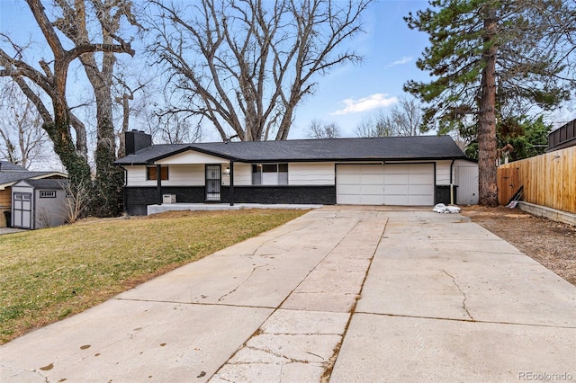 6948 W 70th Ave, Arvada, CO 80003 - view of front of home featuring driveway, a garage, a chimney, and brick siding