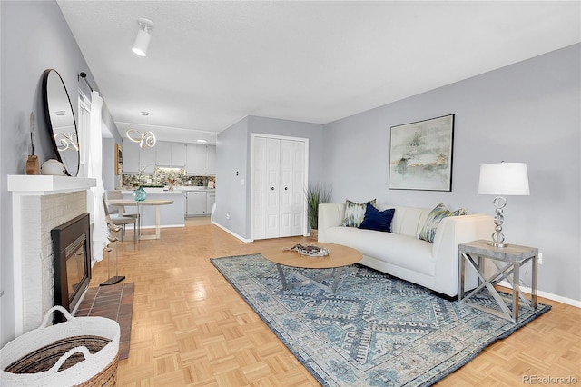 living room featuring a brick fireplace and light parquet floors