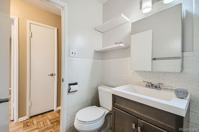 bathroom featuring vanity, tile walls, toilet, and parquet floors