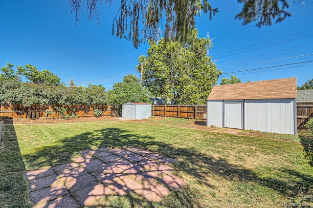 view of yard featuring a shed and a patio area