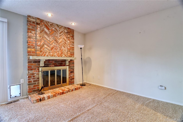 10320 E Jewell Ave Unit 63, Aurora, CO 80247 - unfurnished living room featuring carpet floors, a brick fireplace, a textured ceiling, baseboards, and recessed lighting