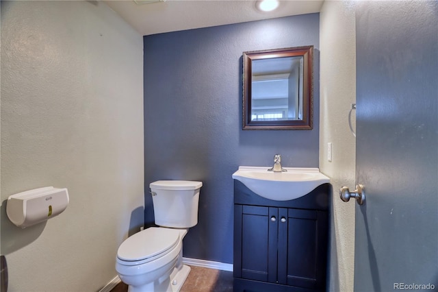 10320 E Jewell Ave Unit 63, Aurora, CO 80247 - bathroom featuring toilet, vanity, and baseboards