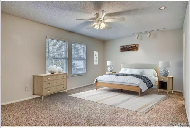 10320 E Jewell Ave Unit 63, Aurora, CO 80247 - bedroom with carpet flooring, a textured ceiling, ceiling fan, and baseboards