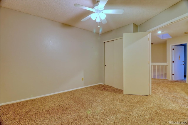 10320 E Jewell Ave Unit 63, Aurora, CO 80247 - unfurnished bedroom featuring carpet floors, a closet, baseboards, and a textured ceiling