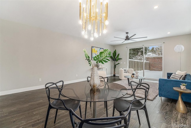 dining room featuring dark hardwood / wood-style floors and ceiling fan with notable chandelier