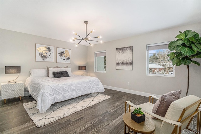 bedroom featuring dark wood-type flooring and a chandelier