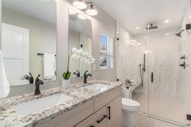 bathroom featuring vanity, tile patterned floors, a shower with door, and toilet