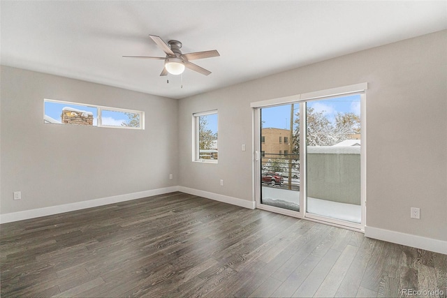 empty room featuring dark wood-type flooring and ceiling fan