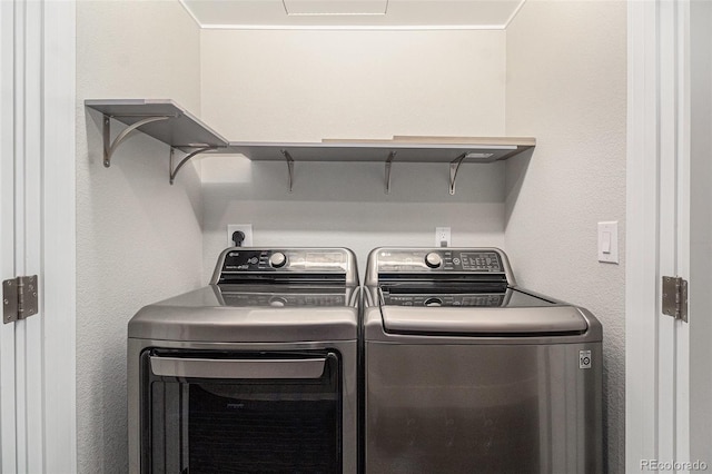 laundry area featuring crown molding and separate washer and dryer