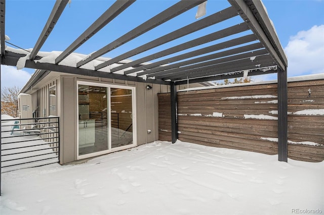 snow covered patio featuring a pergola