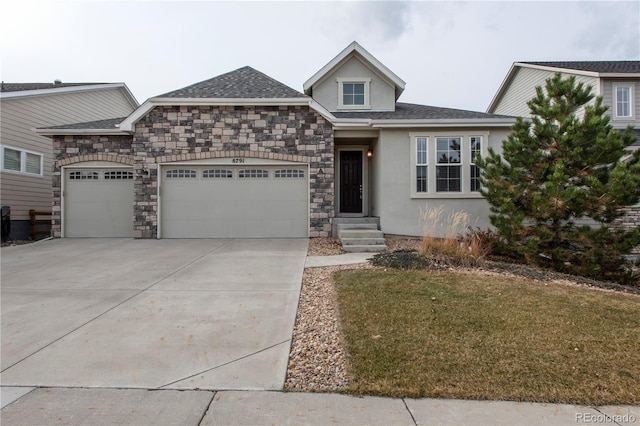 view of front of home featuring a garage, concrete driveway, stone siding, roof with shingles, and stucco siding