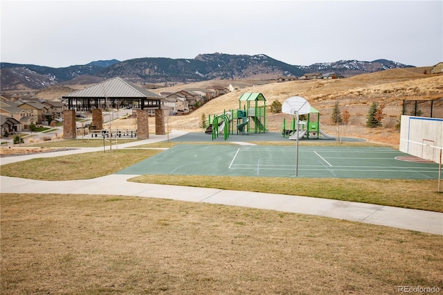 view of property's community featuring playground community, a lawn, a gazebo, and a mountain view