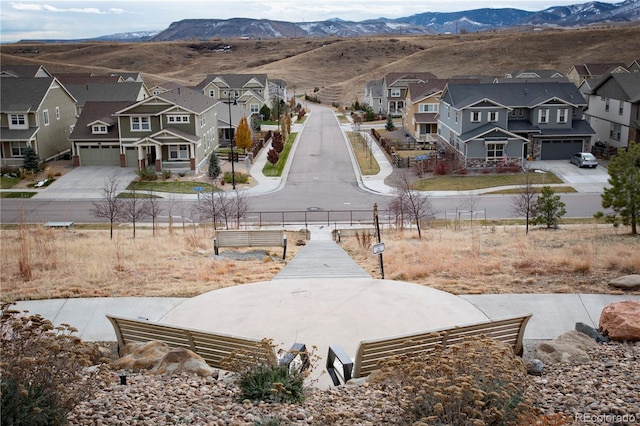 view of yard with driveway, a residential view, and fence