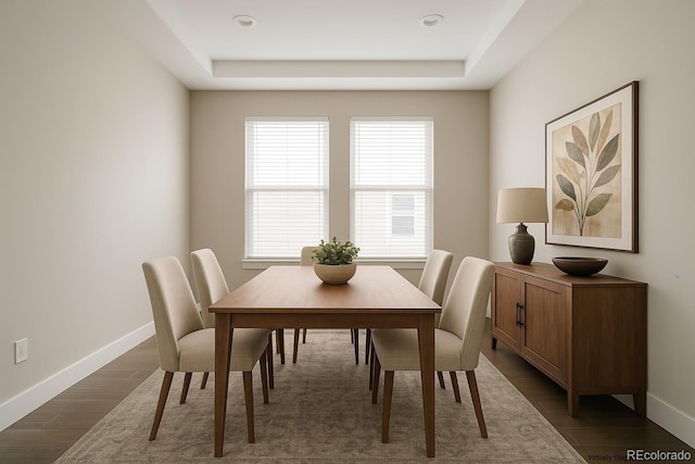 8791 Culebra Ct, Arvada, CO 80007 - dining area featuring a tray ceiling, baseboards, and dark wood finished floors