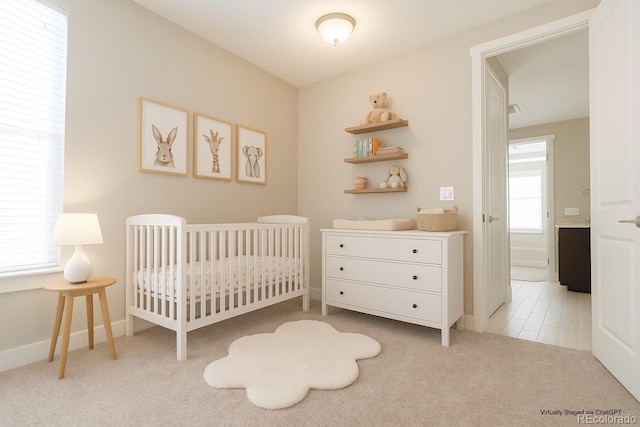 8791 Culebra Ct, Arvada, CO 80007 - bedroom featuring light carpet, a crib, and baseboards