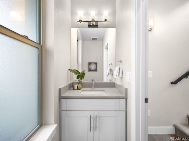 bathroom with vanity and hardwood / wood-style flooring