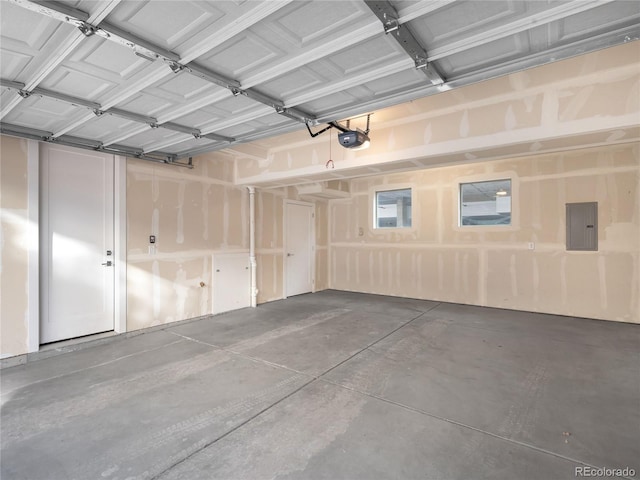 garage with a garage door opener and electric panel