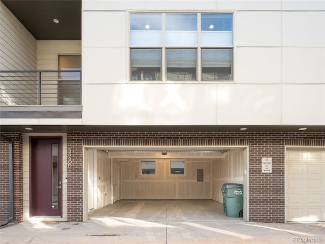 view of exterior entry with a garage and electric panel