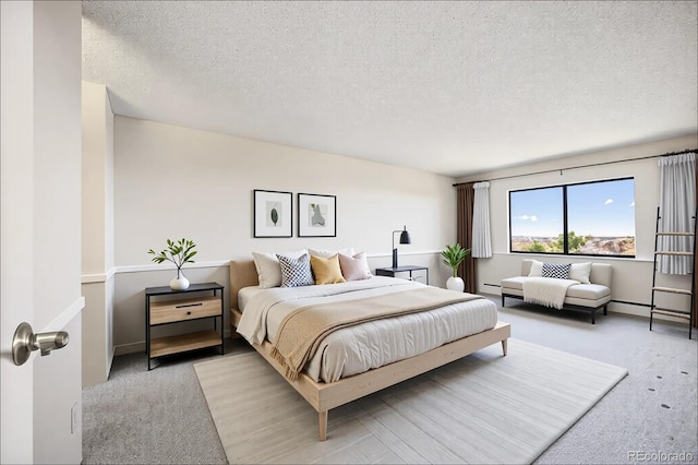 bedroom with light carpet and a textured ceiling
