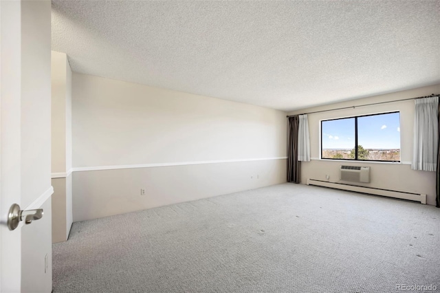 empty room with a baseboard radiator, a textured ceiling, carpet flooring, and a wall mounted air conditioner