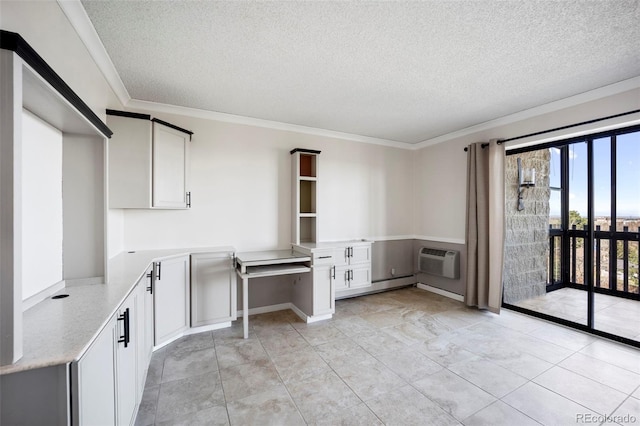 interior space with a textured ceiling, a wall unit AC, and ornamental molding