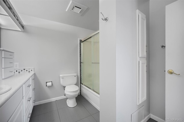 full bath with vanity, toilet, combined bath / shower with glass door, tile patterned floors, and baseboards