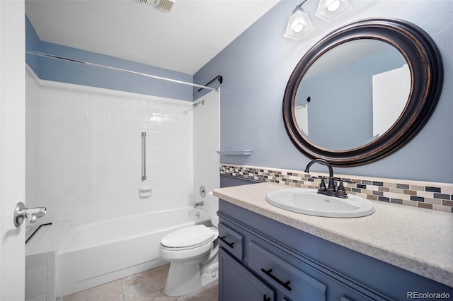 bathroom featuring backsplash, vanity, toilet, and washtub / shower combination