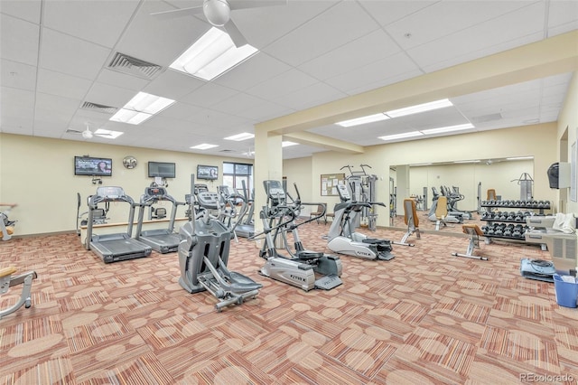 gym featuring carpet floors, a ceiling fan, a drop ceiling, and baseboards