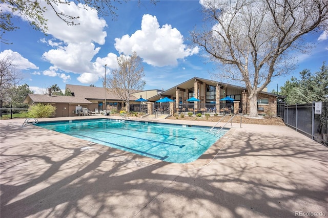 pool featuring a patio and fence