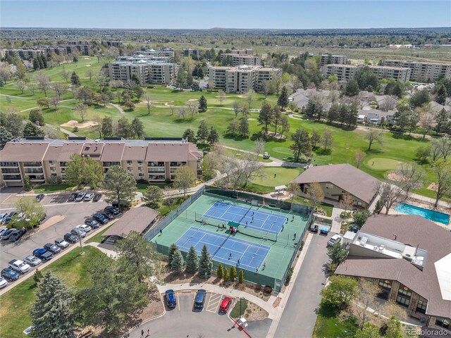 drone / aerial view of apartment complex and a golf course