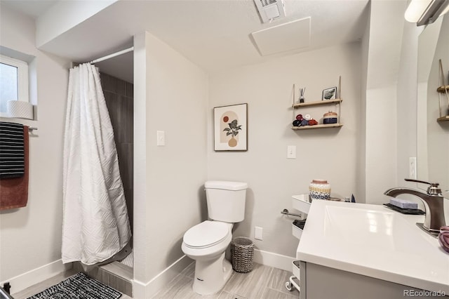 bathroom featuring curtained shower, toilet, and vanity