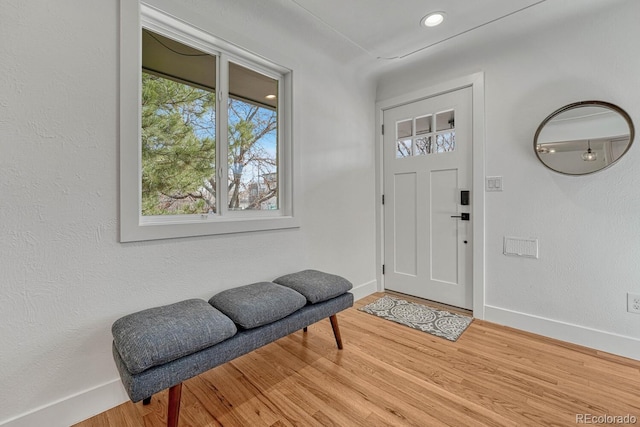 foyer entrance featuring light wood-style floors, baseboards, and recessed lighting