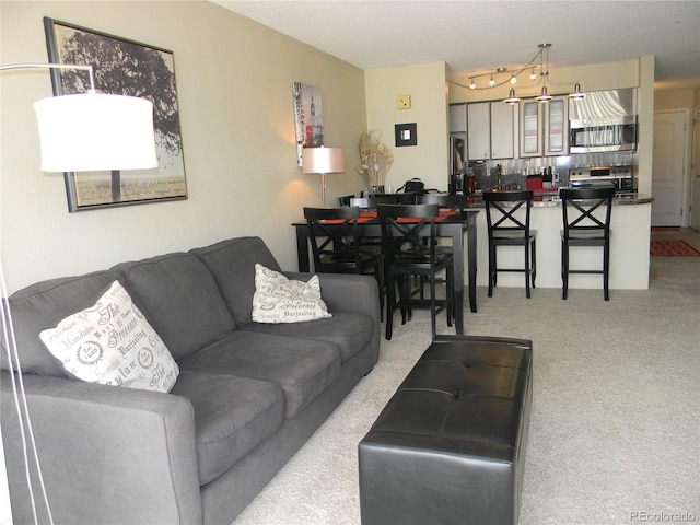 living room featuring light colored carpet and a textured ceiling