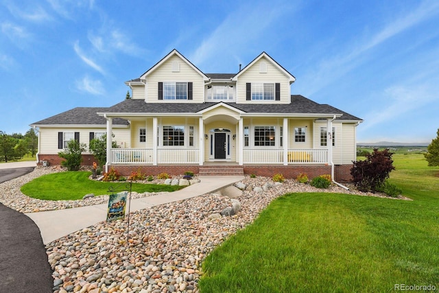 3973 Palmer Ridge Dr, Parker, CO 80134 - view of front of home with a porch, a front lawn, a shingled roof, and brick siding