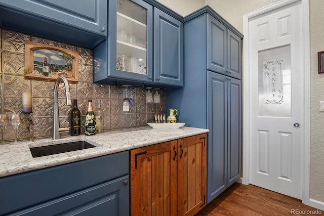 3973 Palmer Ridge Dr, Parker, CO 80134 - indoor wet bar featuring decorative backsplash and dark wood-style flooring