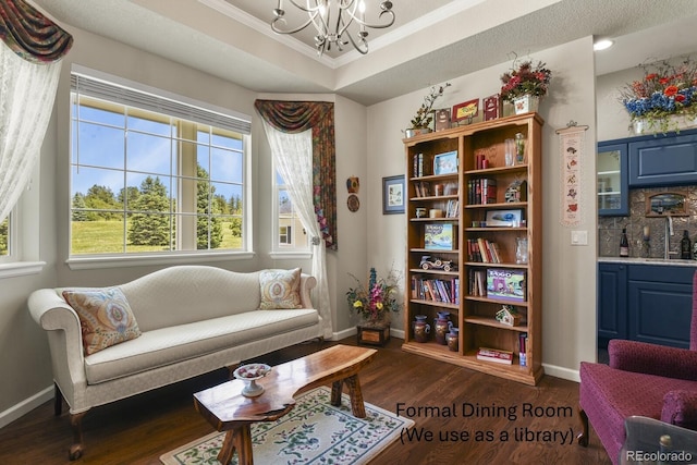 3973 Palmer Ridge Dr, Parker, CO 80134 - sitting room with a chandelier, ornamental molding, plenty of natural light, dark wood-type flooring, and a tray ceiling