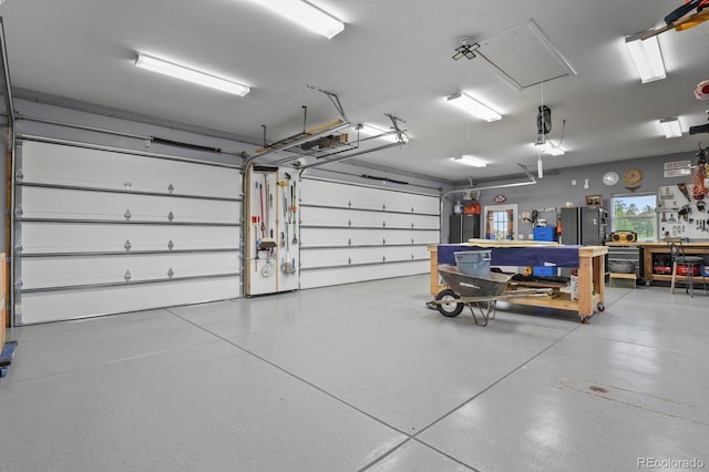 3973 Palmer Ridge Dr, Parker, CO 80134 - garage with freestanding refrigerator and a workshop area