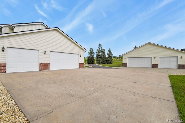 3973 Palmer Ridge Dr, Parker, CO 80134 - view of property exterior featuring brick siding, an outbuilding, and a garage