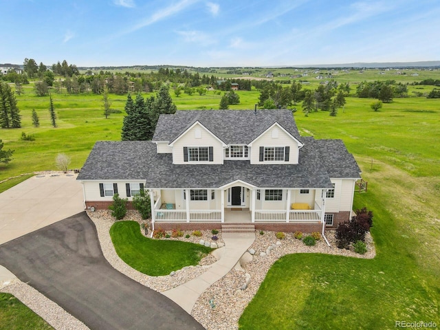 3973 Palmer Ridge Dr, Parker, CO 80134 - view of front of home with covered porch, a shingled roof, and a front yard