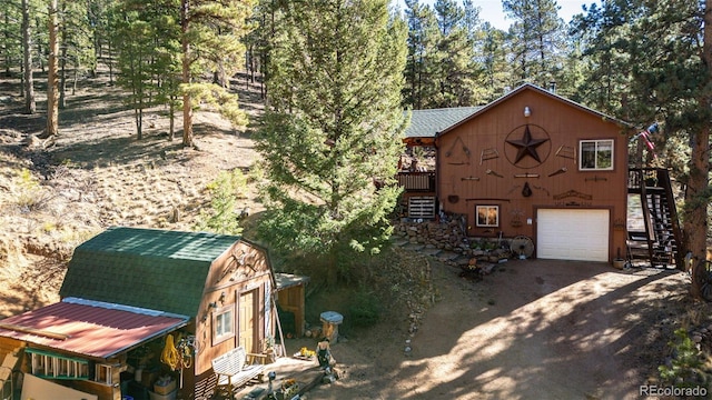 exterior space featuring a wooden deck and a garage