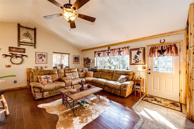 living room with ceiling fan, lofted ceiling, dark hardwood / wood-style floors, and a textured ceiling