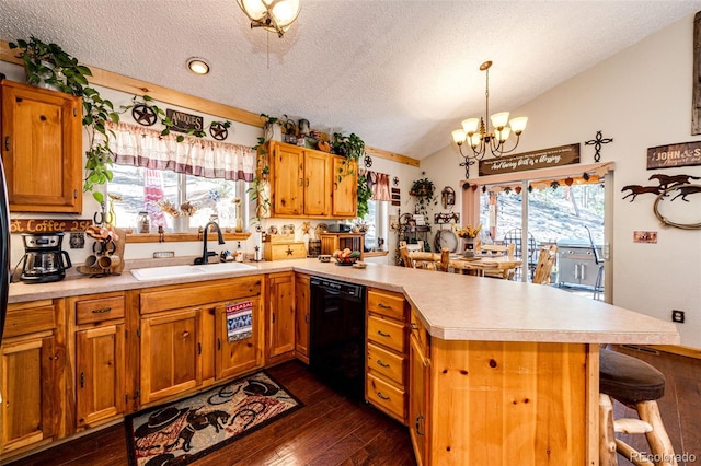 kitchen featuring vaulted ceiling, black dishwasher, sink, and kitchen peninsula