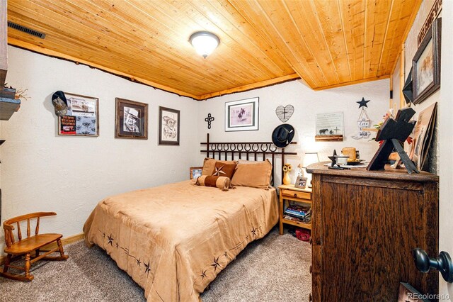 bedroom with wood ceiling and carpet flooring