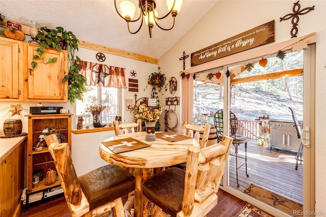 dining space featuring lofted ceiling, an inviting chandelier, a textured ceiling, and dark hardwood / wood-style flooring