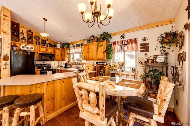 dining space featuring an inviting chandelier, sink, dark wood-type flooring, and a textured ceiling