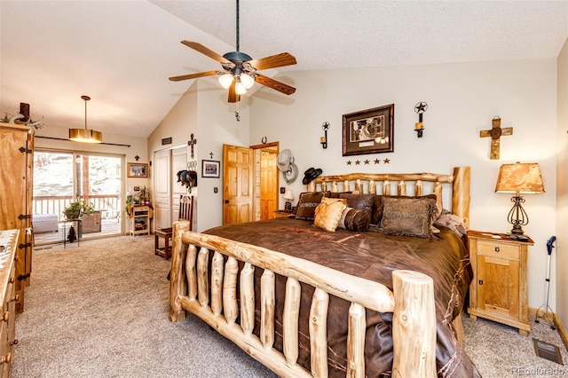 bedroom featuring lofted ceiling, light colored carpet, a textured ceiling, and ceiling fan