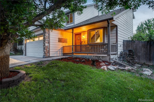 5163 E 123rd Ct, Thornton, CO 80241 - view of front of home with a porch, driveway, a garage, a shingled roof, and stone siding